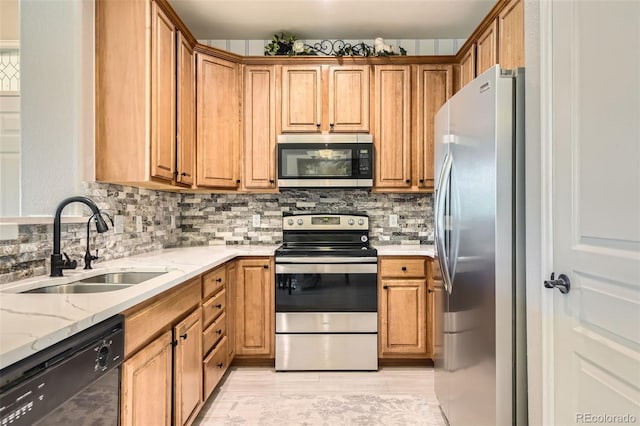 10467 W Hampden Ave Unit 204, Lakewood, CO 80227 - kitchen featuring stainless steel appliances, backsplash, light stone counters, and brown cabinets