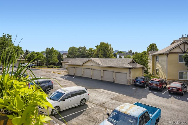 10467 W Hampden Ave Unit 204, Lakewood, CO 80227 - view of front of property featuring community garages, a residential view, and uncovered parking