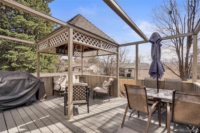 deck with outdoor dining space and a gazebo