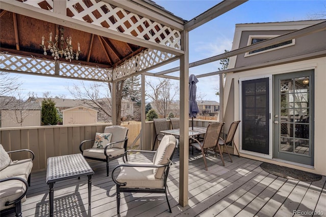 deck with outdoor dining space and a gazebo