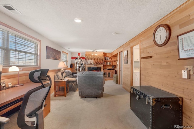 living area featuring light colored carpet, wooden walls, and visible vents