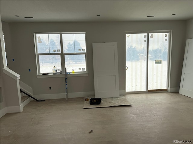 unfurnished living room featuring light wood-type flooring