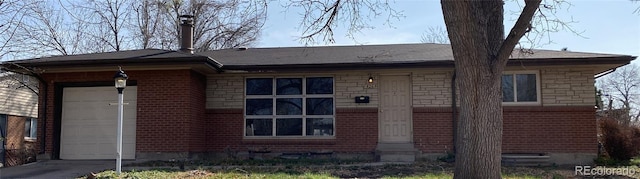 426 Kenton St, Aurora, CO 80010 - view of front of home with a garage, entry steps, stone siding, and brick siding
