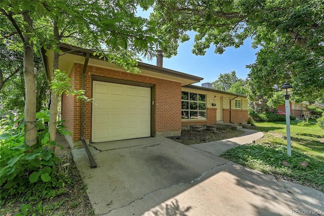 426 Kenton St, Aurora, CO 80010 - ranch-style house with brick siding, a garage, and driveway
