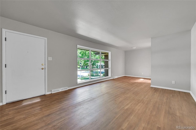 426 Kenton St, Aurora, CO 80010 - unfurnished living room with wood finished floors and baseboards