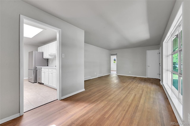 426 Kenton St, Aurora, CO 80010 - unfurnished living room featuring light wood finished floors