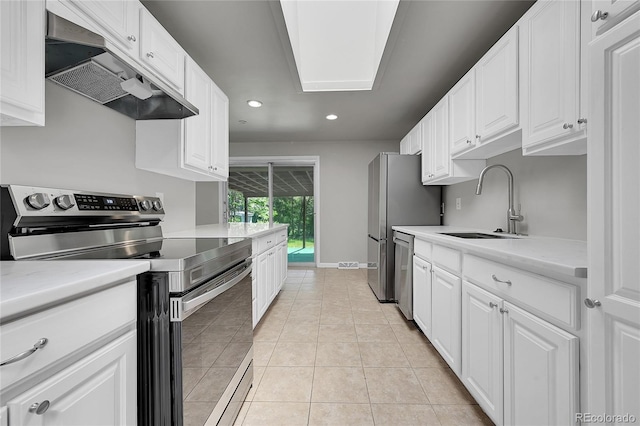 426 Kenton St, Aurora, CO 80010 - kitchen featuring appliances with stainless steel finishes, under cabinet range hood, recessed lighting, light countertops, and white cabinets