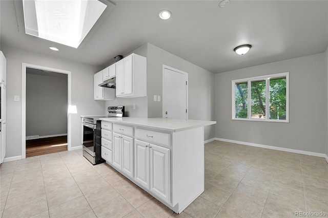 426 Kenton St, Aurora, CO 80010 - kitchen featuring electric range, under cabinet range hood, a skylight, light tile patterned flooring, and recessed lighting