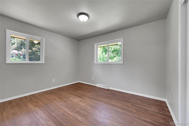 426 Kenton St, Aurora, CO 80010 - empty room with dark wood-style floors and baseboards