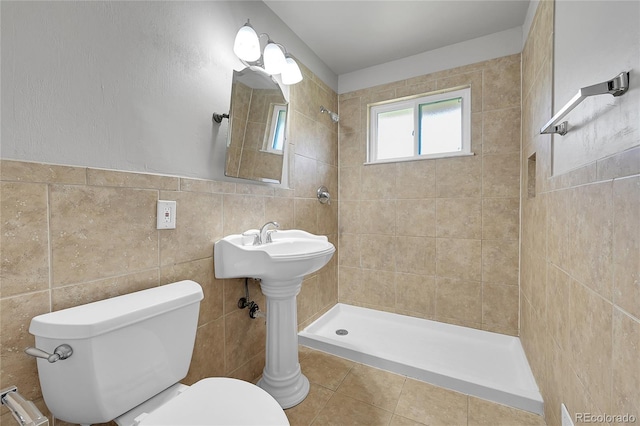 426 Kenton St, Aurora, CO 80010 - bathroom with tiled shower, tile walls, and tile patterned flooring