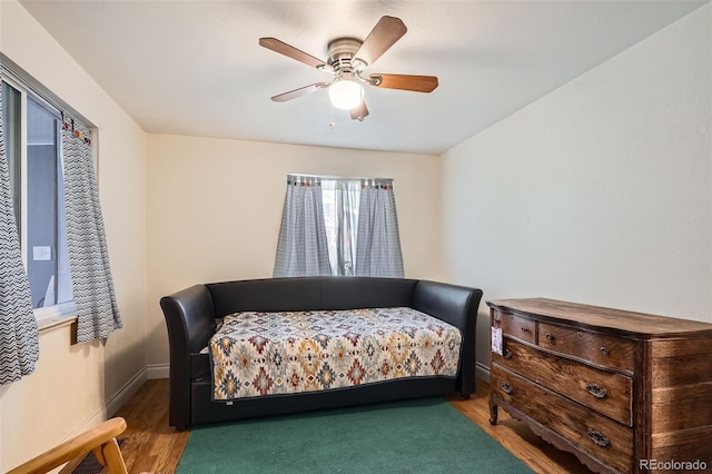 bedroom with ceiling fan and dark hardwood / wood-style floors