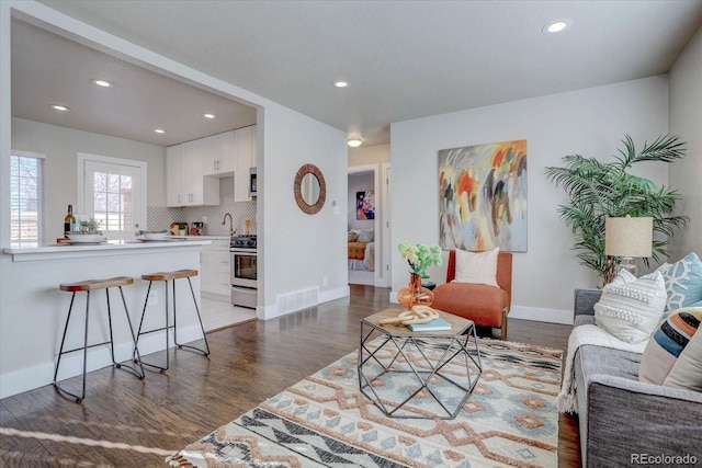 living room with dark hardwood / wood-style flooring