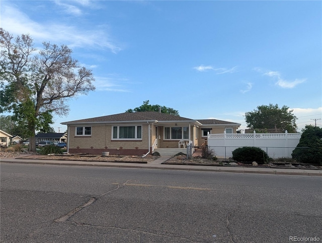1009 Bush St, Brighton, CO 80601 - ranch-style home with fence and brick siding