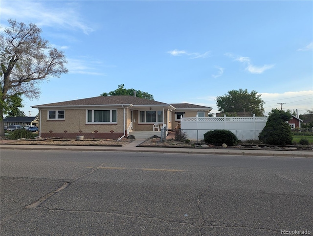 1009 Bush St, Brighton, CO 80601 - view of front of property with fence and brick siding