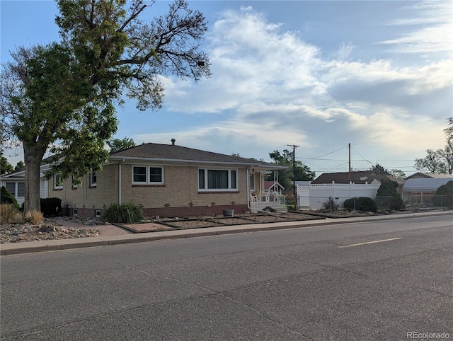 1009 Bush St, Brighton, CO 80601 - view of front of property with fence and brick siding