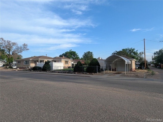 1009 Bush St, Brighton, CO 80601 - ranch-style home featuring fence, a garage, a residential view, and a carport