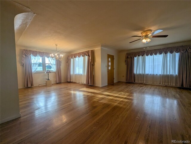 1009 Bush St, Brighton, CO 80601 - empty room with a chandelier, ceiling fan, wood finished floors, and baseboards