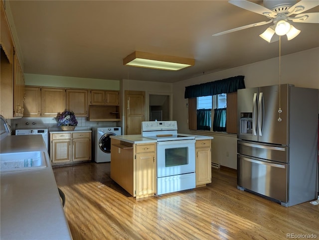 1009 Bush St, Brighton, CO 80601 - kitchen featuring stainless steel fridge with ice dispenser, washer / clothes dryer, electric range, light countertops, and a center island