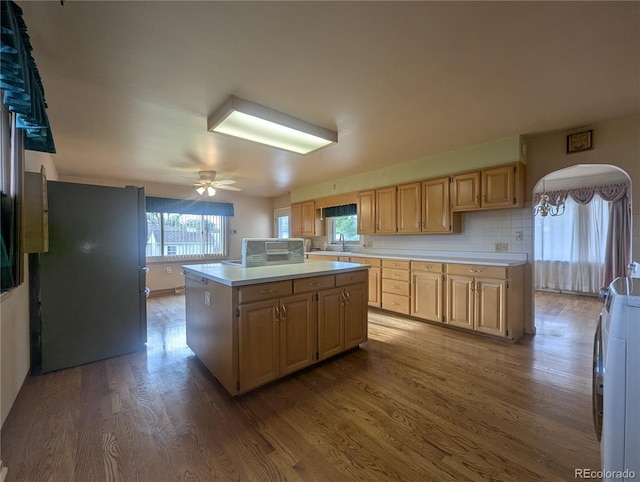 1009 Bush St, Brighton, CO 80601 - kitchen featuring freestanding refrigerator, wood finished floors, light countertops, a kitchen island, and ceiling fan