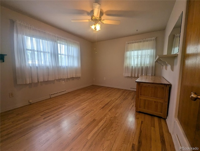 1009 Bush St, Brighton, CO 80601 - empty room with healthy amount of natural light, wood finished floors, ceiling fan, and baseboards