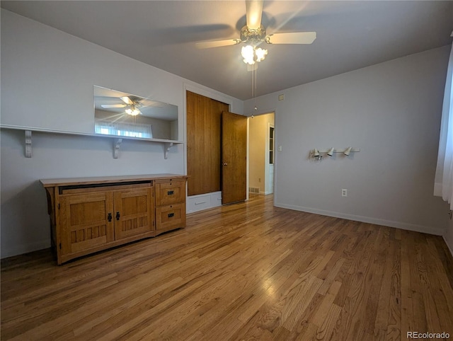 1009 Bush St, Brighton, CO 80601 - unfurnished bedroom with light wood-style flooring, ceiling fan, and baseboards