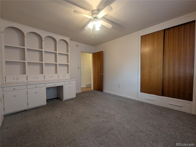 1009 Bush St, Brighton, CO 80601 - unfurnished office featuring ceiling fan, carpet flooring, built in desk, and baseboards