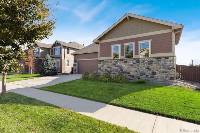 craftsman-style home featuring a garage and a front lawn