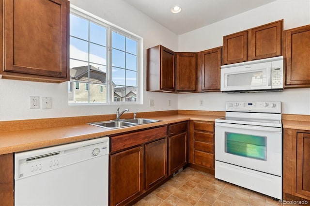 kitchen featuring white appliances and sink