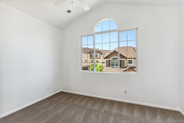 unfurnished room with dark carpet, ceiling fan, and vaulted ceiling