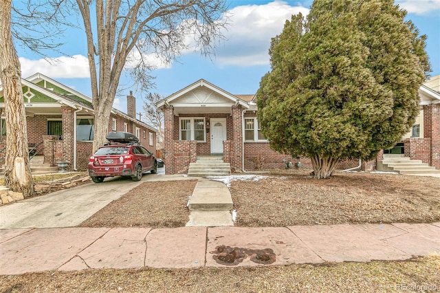 view of front facade featuring covered porch and brick siding