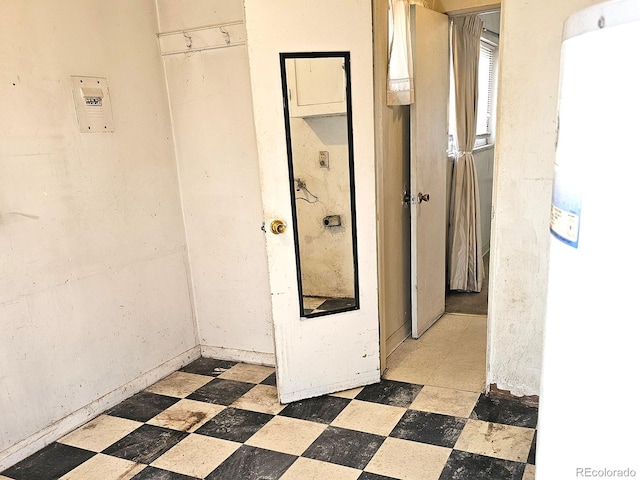 hall with tile patterned floors and water heater