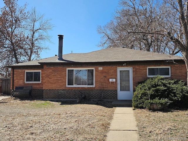 bungalow-style home with brick siding and a shingled roof