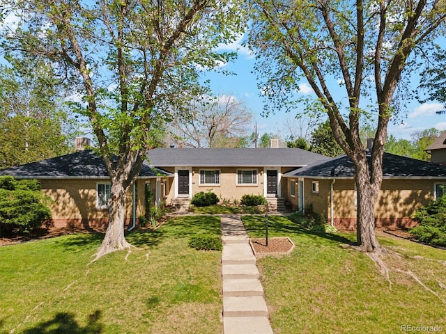 236 S Clarkson St, Denver, CO 80209 - view of front of property featuring brick siding, a front lawn, and a chimney