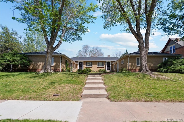 236 S Clarkson St, Denver, CO 80209 - view of front facade featuring brick siding and a front yard