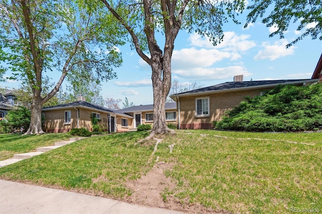 236 S Clarkson St, Denver, CO 80209 - view of front of home featuring brick siding and a front yard