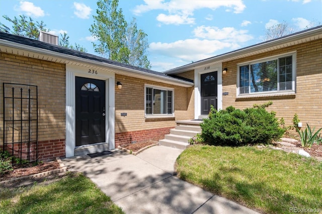 236 S Clarkson St, Denver, CO 80209 - view of exterior entry featuring brick siding and a yard