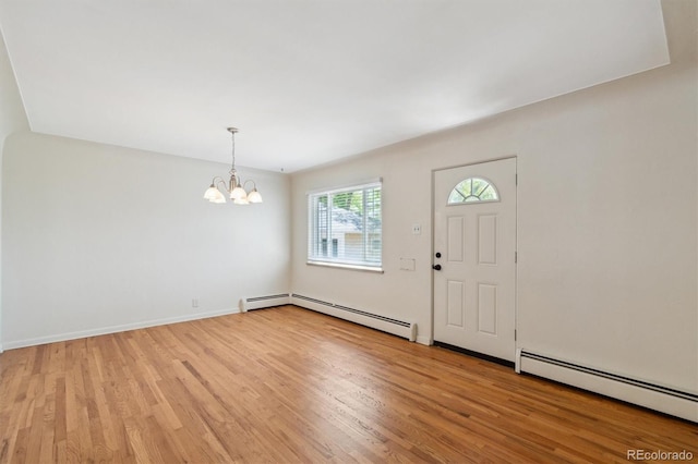 236 S Clarkson St, Denver, CO 80209 - entrance foyer featuring a baseboard heating unit, a chandelier, and light wood-style flooring