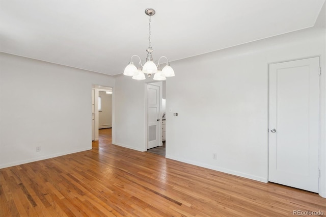 236 S Clarkson St, Denver, CO 80209 - unfurnished room with a chandelier, baseboards, and light wood finished floors