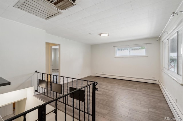 236 S Clarkson St, Denver, CO 80209 - spare room with baseboard heating and wood finished floors