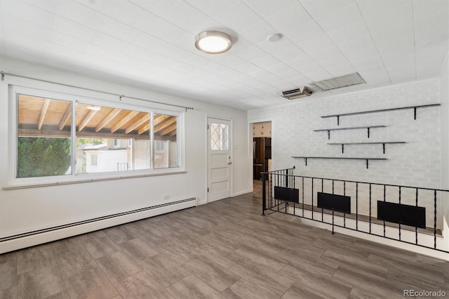 236 S Clarkson St, Denver, CO 80209 - unfurnished living room featuring baseboard heating, healthy amount of natural light, and wood finished floors