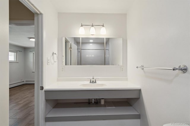236 S Clarkson St, Denver, CO 80209 - bathroom featuring vanity, baseboard heating, wood finished floors, and a shower