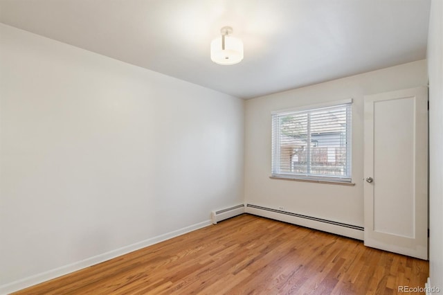 236 S Clarkson St, Denver, CO 80209 - spare room featuring light wood-type flooring, baseboard heating, and baseboards