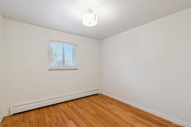 236 S Clarkson St, Denver, CO 80209 - unfurnished room with a baseboard radiator, light wood-style floors, and baseboards