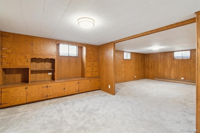 236 S Clarkson St, Denver, CO 80209 - below grade area featuring a baseboard heating unit, wood walls, and light colored carpet
