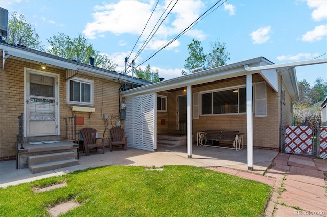 236 S Clarkson St, Denver, CO 80209 - back of property with brick siding, a lawn, and a patio
