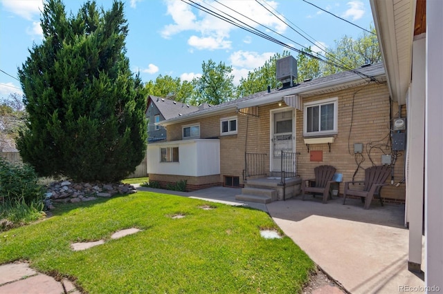 236 S Clarkson St, Denver, CO 80209 - back of property featuring brick siding, a lawn, central air condition unit, and a patio area