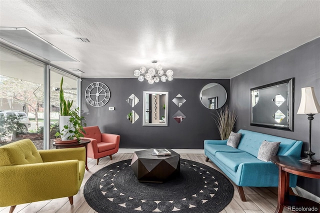 800 N Washington St Unit 804, Denver, CO 80203 - living area with wood finished floors, a textured ceiling, a chandelier, floor to ceiling windows, and baseboards