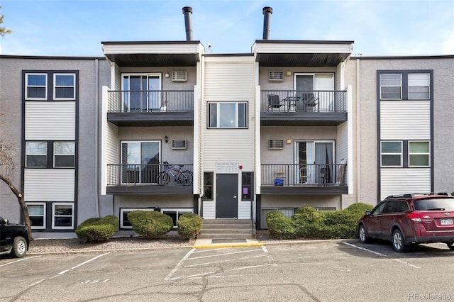 view of property featuring uncovered parking