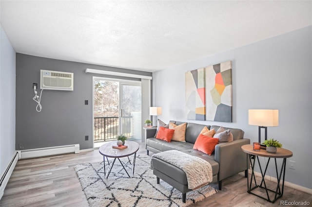 living area featuring a wall unit AC, wood finished floors, baseboards, and baseboard heating