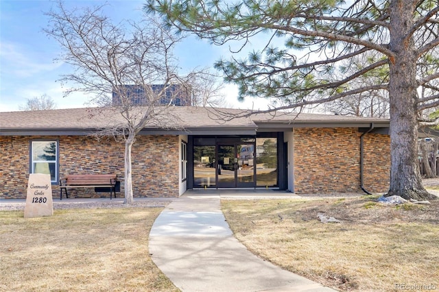 doorway to property with stone siding